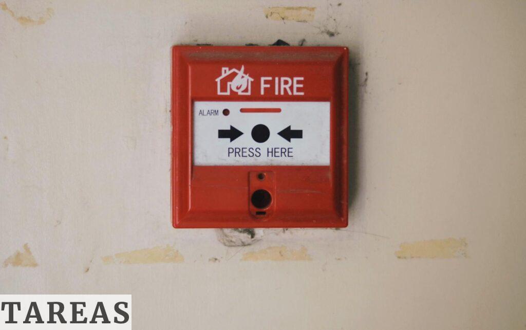 Emergency safety fire detection system box for safety with inscription and push button placed on white wall in light room